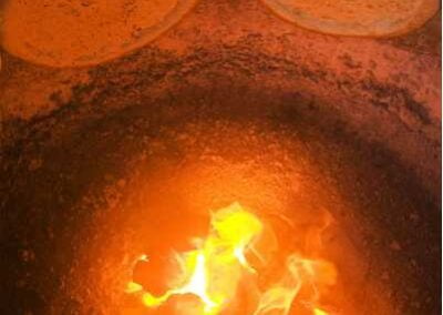 Naan flatbreads stick on the oven side surface